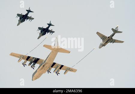 A US Marine Corps (USMC) KC-130J Hercules aircraft simulates aerial refueling with an EA-6B Prowler and two AV-8B Harrier II aircraft at the conclusion of the Marine Air Ground Task Force (MAGTF) demonstration during the 2005 Air Show, held at Marine Corps Air Station (MCAS) Cherry Point, North Carolina (NC). Base: Mcas, Cherry Point State: North Carolina (NC) Country: United States Of America (USA) Scene Major Command Shown: MAGTF Stock Photo