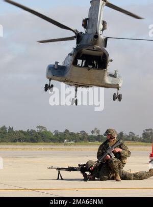 US Marine Corps (USMC) Lance Corporal (LCPL) Jason Sutherlin (right, kneeling) and LCPL Howard Miller, establish a hasty security perimeter around the landing zone, after disembarking from a USMC CH-46 Sea Knight helicopter, during a simulated embassy reinforcement exercise, conducted at the Joint Forces Reserve Training Center (JFRTC), at Fort Irwin, California (CA). The exercise was part of the 13th Marine Expeditionary Unit's (MEU) Special Operations Capable Exercise (SOCEX), designed to prepare Marines for an upcoming Western Pacific deployment. Base: Fort Irwin Jfrtc State: California (CA Stock Photo