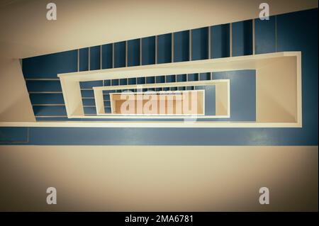 Staircase with white banister and blue vinyl floor from top to bottom, Jena Thuringia, Germany Stock Photo