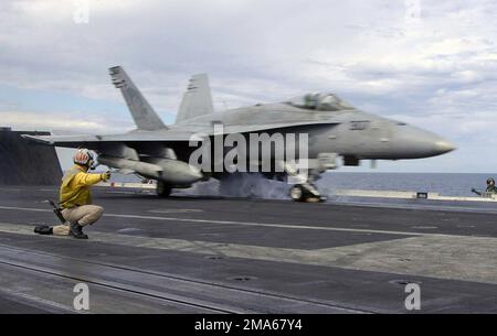 050622-N-8604L-127. [Complete] Scene Caption: A US Navy (USN) F/A-18C Hornet, Strike Fighter Squadron 192 (VFA-192), Golden Dragons, Naval Air Facility (NAF) Atsugi, Japan (JPN), launches from the flight deck aboard the USN Aircraft Carrier USS KITTY HAWK (CV 63). The HAWK is currently operating in the Coral Sea in support of Exercise TALISMAN SABRE 2005. TALISMAN SABRE is an exercise jointly sponsored by the US Pacific Command (USPACOM) and Australian Defense Force Joint Operations Command, and designed to train the US 7th Fleet Commander's staff and Australian Joint Operations staff as a des Stock Photo