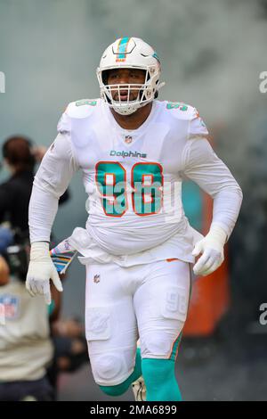 Miami, United States. 25th Dec, 2022. Miami. FL USA; Miami Dolphins safety  Elijah Campbell (22) and defensive tackle Raekwon Davis (98) celebrate  after tackling Green Bay Packers cornerback Keisean Nixon (25) during