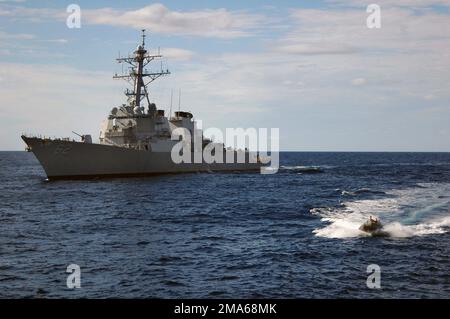 050622-N-5781F-047. [Complete] Scene Caption: A US Navy (USN) Rigid Hull Inflatable Boat (RHIB) returns to the USN Ticonderoga Class Guided Missile Cruiser USS COWPENS (CG 63) after a conduct exercise. The COWPENS is accompanying the USN Aircraft Carrier USS KITTY HAWK (CV 63) and other ships of the Kitty Hawk Carrier Strike Group (CSG), as part of Exercise TALISMAN SABER 2005. TALISMAN SABRE is an exercise jointly sponsored by the US Pacific Command (USPACOM) and Australian Defense Force Joint Operations Command, and designed to train the US 7th Fleet Commander's staff and Australian Joint Op Stock Photo