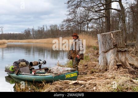 Working boat, kayak of a nature photographer, nature photographer observing, Naturpark Flusslandschaft Peenetal, Mecklenburg-Western Pomerania Stock Photo