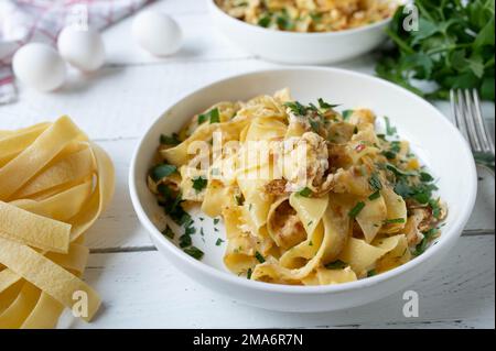 Pasta with scrambled eggs and parsley on a plate Stock Photo
