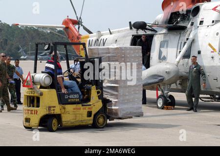 US Navy (USN) Sailors, stationed onboard Naval Air Station (NAS) Pensacola, Florida (FL), load palletized supplies onto a USN Sikorsky SH-3H Sea King Helicopter in order to deliver these relief supplies to the victims of Hurricane Katrina living in New Orleans, Louisiana (LA). These Sailors are part of the US Navys contribution to the humanitarian assistance operation, led by the Federal Emergency Management Agency (FEMA) and working in conjunction with the Department of Defense (DoD), that is delivering humanitarian and relief assistance to the Gulf Coast victims of Hurricane Katrina. Base: N Stock Photo