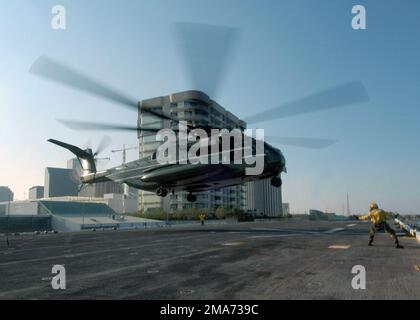 050911-N-8933S-001. [Complete] Scene Caption: Marine One a US Marine Corps (USMC) CH-53E Super Stallion helicopter, assigned to Marine Helicopter Squadron One (HMX-1), lands on the flight deck of the US Navy (USN) Wasp Class, Amphibious Assault Ship, USS IWO JIMA (LHD 7) in New Orleans, Louisiana (LA), as US President George W. Bush arrives aboard ship. President Bush visited the ship while in New Orleans, Louisiana (LA) observing first hand the results of the rescue and recovery missions carried out by the military currently assisting in Joint Task Force Katrina hurricane relief efforts. The Stock Photo