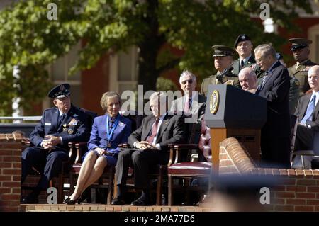 050930-F-2270A-033. [Complete] Scene Caption: U.S. Air Force GEN. Richard B. Myers (seated, left), Chairman of the Joint Chiefs of STAFF, Mrs. Mary Jo Myers (seated, center), and the Honorable George W. Bush (seated, right), President of the United States, listen as The Honorable Donald H. Rumsfeld (standing at the lectern), U.S. Secretary of Defense, speaks to the audience about the accomplishments of GEN. Myers and U.S. Marine Corps GEN. Peter Pace, Vice Chairman of the Joint Chiefs of STAFF (and incoming Chairman of the Joints Chiefs of STAFF), during the Armed Forces Farewell Tribute in Ho Stock Photo