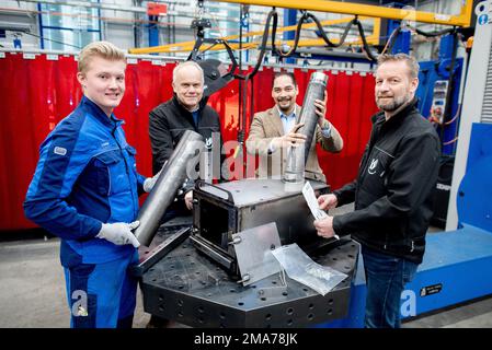 Meppen, Germany. 18th Jan, 2023. Jonathan Kestel (l-r), apprentice at Kuipers Technologies, Heiner Meiners, member of the Helping Hands aid organization, Michael Kuipers, Managing Director of Kuipers Technologies, and Markus Vähnig, Chairman of the Helping Hands aid organization, assemble a new field oven. The aid organization Helping Hands e.V. from Lathen, the company Kuipers from Meppen and other actors donate 760 field ovens, which will be brought to the war zones in Ukraine as well as to Moldova, which is strongly affected by the war. Credit: Hauke-Christian Dittrich/dpa/Alamy Live News Stock Photo