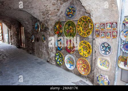 Decorated plates ceramics shop in Ravello, Italy  on the walls of the street Ravello, Italy - Amalfi Coast Stock Photo