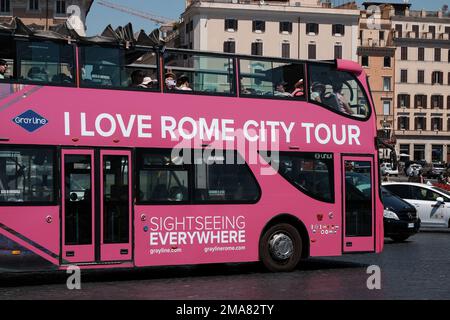 I love Rome city tour bus with passengers looking from windows at Vittorio Emmanuele monument. Stock Photo