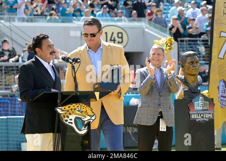 Former Jacksonville Jaguars offensive tackle Tony Boselli, center, is  presented with his Pro Football Hall of Fame ring and had his jersey number  retired, by owner Shahid Khan, left, as Pro Football Hall of Fame president  Jim Porter listens during half