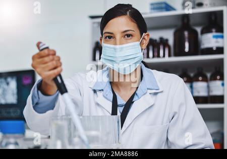 Testing my hypothesis. a young female researcher working in a laboratory. Stock Photo