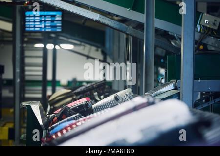 Lot of luggage on conveyor belt. Baggage sorting at airport. Traveling by airplane. Stock Photo