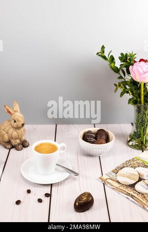 Decorated easter egg chocolates with espresso at set table Stock Photo