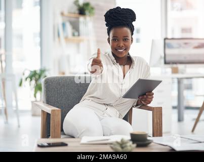 Its been a great day. a businesswoman using her digital tablet at work. Stock Photo