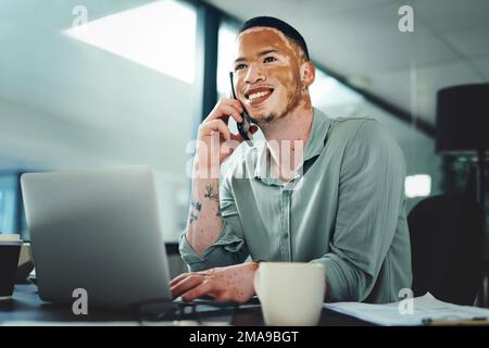 Making connections is as easy as picking up a phone. a young businessman on a call while using a laptop in an office. Stock Photo