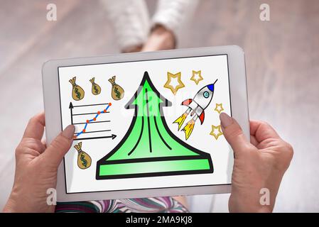 Success concept shown on a tablet held by a woman Stock Photo
