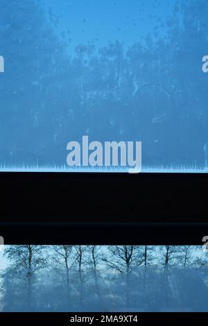 Ice crystals formed on glass. A window from inside looking out. Stock Photo