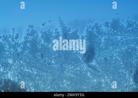 Ice crystals formed on glass. A window from inside looking out. Stock Photo