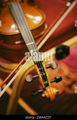 Detail view of a violin on a black chair. Stock Photo