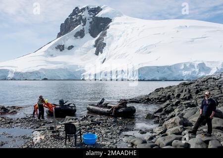 Antarctic tour guides await the return of tourists they have put ashore at Palava  Point Antarctic peninsula Stock Photo