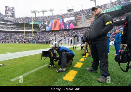 An NFL Films camera operator works during the first half of a