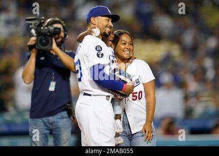 Kynlee Betts, center, greets her father, Los Angeles Dodgers right fielder Mookie  Betts (50), after she
