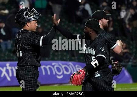 Chicago White Sox catcher Carlos Perez and second baseman Josh Harrison  celebrate the team's 3-2 win over the Minnesota Twins after a baseball game  Monday, Oct. 3, 2022, in Chicago. (AP Photo/Charles