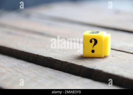 Question mark on a yellow cube. Place for text. Vintage style. Stock Photo