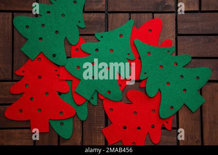 Christmas decorations handmade from red and green felt on a wooden background. Stock Photo