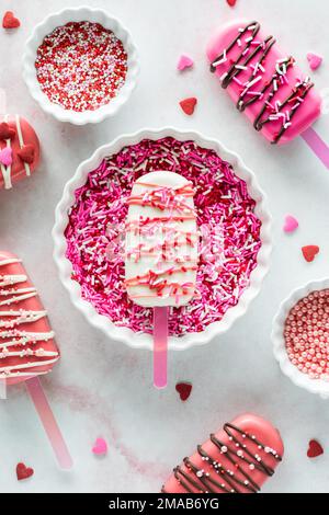 A homemade cakesicle decorated with edible bees in a bowl full of sprinkles  Stock Photo - Alamy