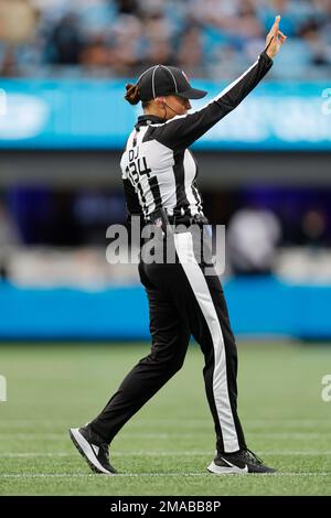 NFL down judge Robin Delorenzo, right, hands a penalty flag to