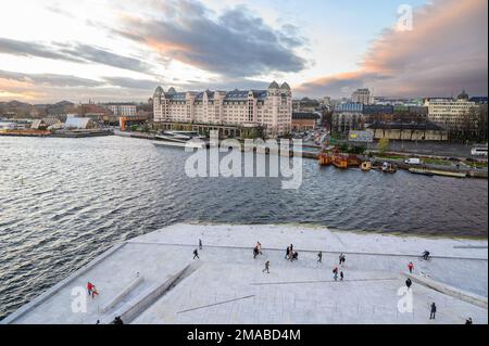 View from the rooftop of Oslo Opera House towards the Havnelageret building and city centre skyline at dusk. Oslo, Norway. Stock Photo