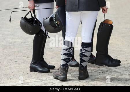 29.05.2022, Germany, Saxony, Graditz - Close-up: Rider holding riding helmet, riding crop, boots and uniform cap in his hands. 00S220529D089CAROEX.JPG Stock Photo