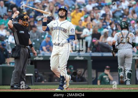 Seattle Mariners' Eugenio Suarez, center, and Root Sports journalist Jen  Mueller, right, are doused with ice water by catcher Tom Murphy, left,  during an interview after the Mariners beat the Texas Rangers