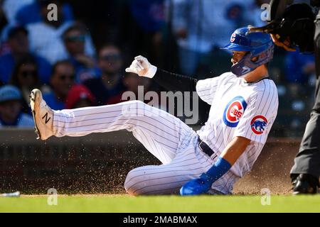 Seiya Suzuki of the Chicago Cubs hits a sacrifice fly in the first inning  of a baseball game against the Milwaukee Brewers on April 9, 2022, at  Wrigley Field in Chicago. (Kyodo)==Kyodo