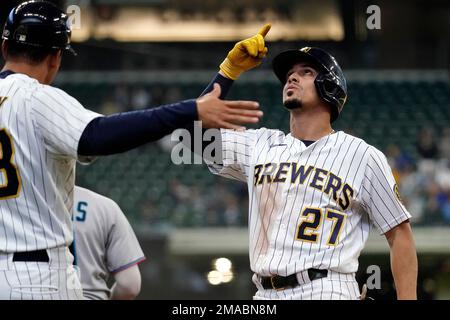 Milwaukee Brewers' Willy Adames, right, places a cheesehead hat on teammate  Rowdy Tellez after Tellez hit a two-run home run during the first inning of  a baseball game against the San Diego