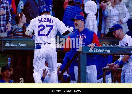 The Chicago Cubs' Seiya Suzuki (L) high fives Frank Schwindel