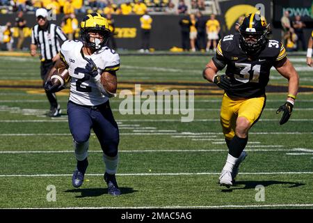 Michigan running back Blake Corum 2 runs from Iowa linebacker