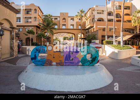 This colorful concrete sign is popular with tourists. Everyone has to take their photo on this as part of their memories of Cabo San Lucas, Mexico Stock Photo