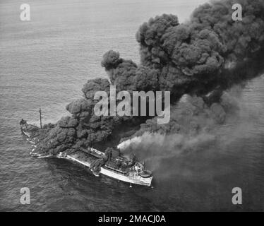 A vintage photo circa 1942/1943 of an American oil tanker on fire in the Atlantic after being torpedoed by a German submarine or U-boat during world war two Stock Photo