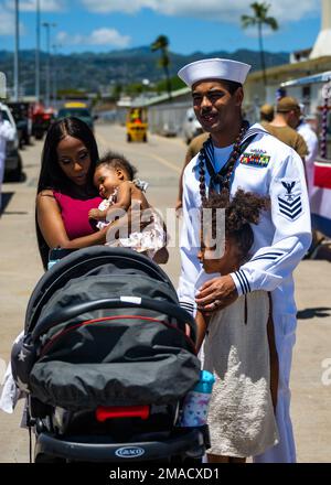 220525-N-LN285-2394 JOINT BASE PEARL HARBOR-HICKAM (May 25, 2022) -- Fire Control Technician 1st Class Lamarr Hall, from Detroit, assigned to the Virginia-class fast-attack submarine USS North Carolina (SSN 777) reunites with his family after the boat returns to Joint Base Pearl Harbor-Hickam from deployment in the 7th Fleet area of responsibility. North Carolina performed a full spectrum of operations, including anti-submarine and anti-surface warfare, during the extended seven-month, Indo-Pacific deployment. Stock Photo
