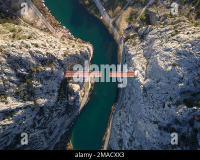 Aerial drone view of Unfinished bridge in Omis, Croatia over the river Cetina. Bridge being built in between the canyon. Stock Photo