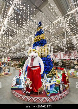 The symbol of 2023 is a large hare near the Christmas tree in the supermarket. Dnipro, Ukraine, January 6, 2023 Stock Photo