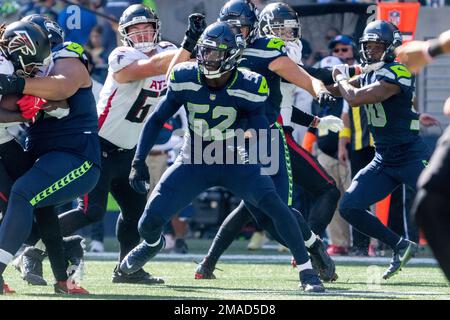 Los Angeles, California, USA. 23rd Oct, 2022. Seattle Seahawks linebacker Darrell  Taylor (52) is tackled by Los Angeles Chargers quarterback Justin Herbert  (10) during the first half at an NFL football game