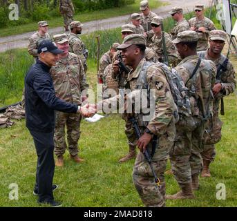 United States Military Academy (USMA) football coach visits his players, Cadets with USMA, at Camp Buckner in West Point, Ny., May 25, 2022. The purpose of Cadet Leadership Development Training is to prepare Cadets for tactical leadership positions at the platoon. Graduates will demonstrate confidence and proficiency in leadership attributes by applying the Army's Operation Process in the preparation and execution of missions to prepare cadets for the rank of Lieutenant after commissioning. Stock Photo