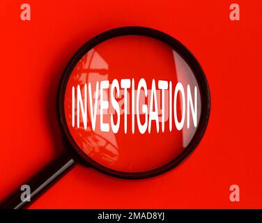 Investigation text on red cover with magnifying glass. Scamming and fraud concept Stock Photo