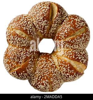 Eating continental breakfast - gold bread roll (bagel) with sesame, isolated on white, fresh pastries Stock Photo