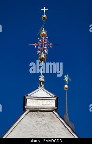 Estonia, Tallinn, ornate wrought iron cross on town hall. Stock Photo