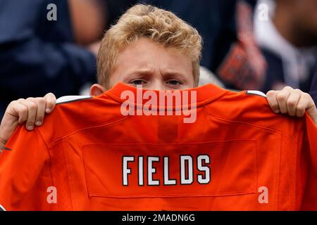 A Chicago Bears fan holds a quarterback Justin Fields jersey before an NFL  football game against the Houston Texans Sunday, Sept. 25, 2022, in Chicago.  (AP Photo/Nam Y. Huh Stock Photo - Alamy